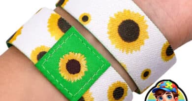 Pulseira girassol para identificação de deficiências invisíveis no pulso, em branco com girassóis amarelos e bandeira do Brasil