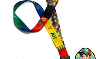 Cordão Dupla Face TDAH + Autismo com trava anti-sufocamento e símbolos de girassol e quebra-cabeça, ideal para identificação segura.